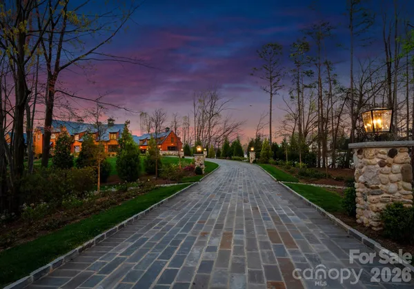 a view of a pathway with a wrought fence