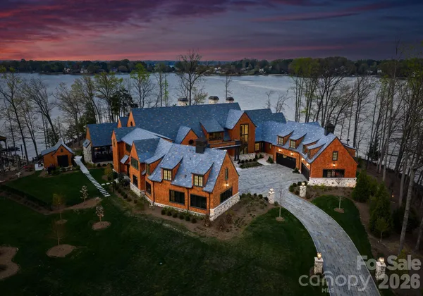 an aerial view of a house with a yard basket ball court and outdoor seating