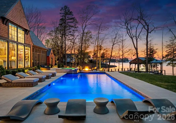 a swimming pool with outdoor seating and yard