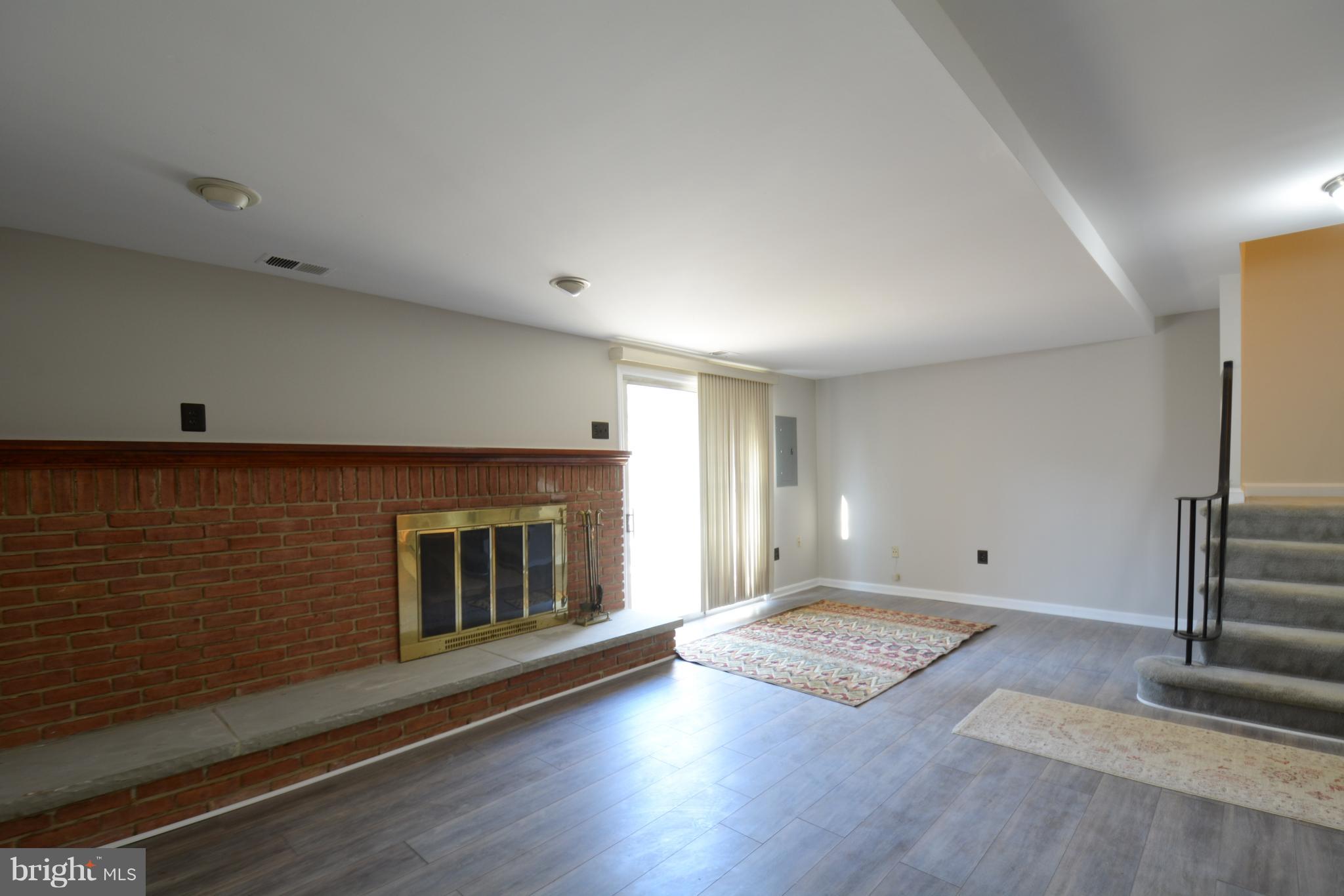 8985 Omega Court Springfield, VA 22152 - Photo 14 of 25 Basement Rec Room With Engineered Floor