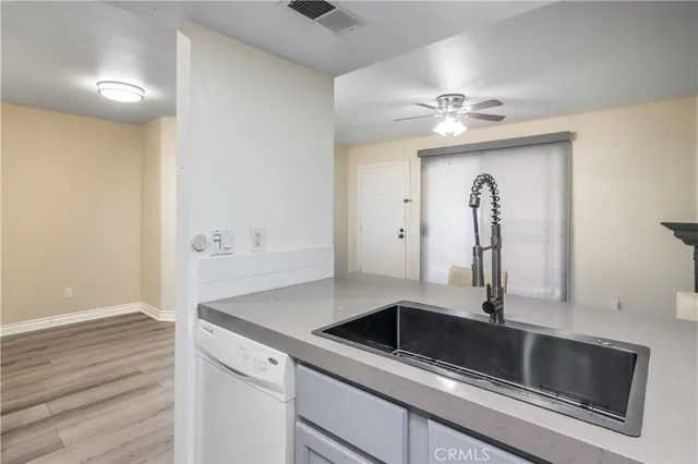 a kitchen with refrigerator and cabinets