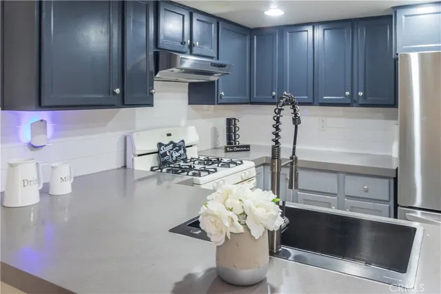 a kitchen with a sink and a refrigerator