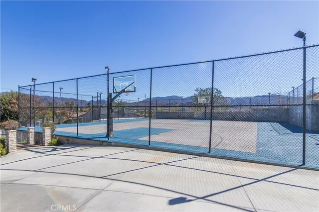 a view of backyard with swimming pool and seating space