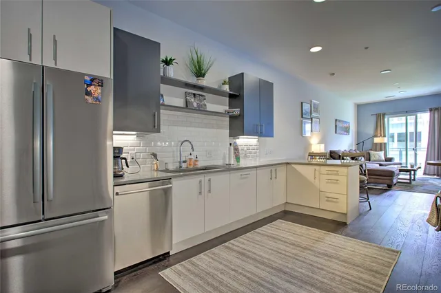 a kitchen with white cabinets and refrigerator