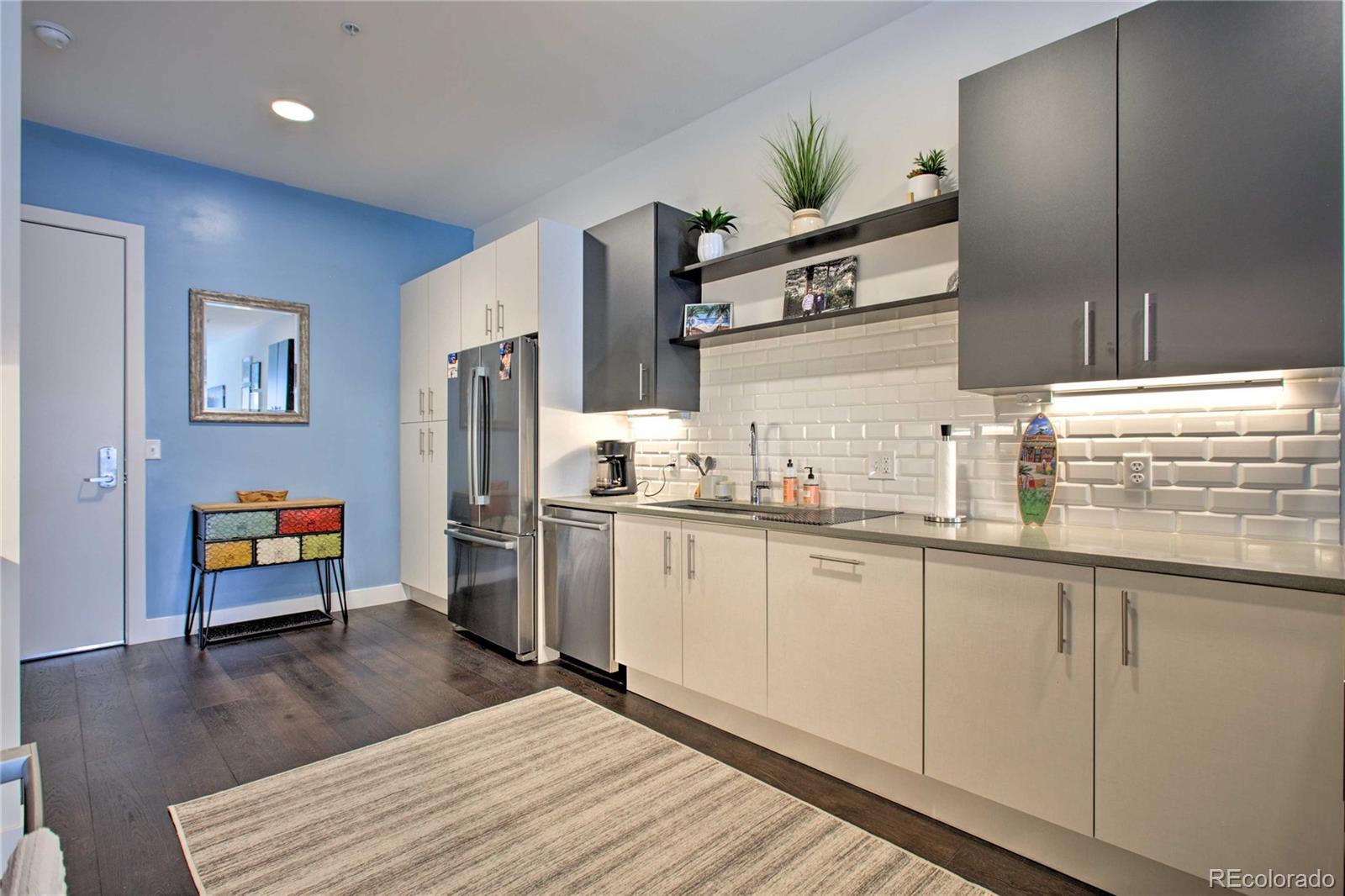 2550 Lawrence Street, Unit RB204 Denver, CO 80205 - Photo 12 of 36 a kitchen with stainless steel appliances granite countertop a refrigerator a stove and a sink