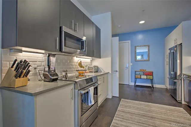 a kitchen with stainless steel appliances granite countertop a stove and a refrigerator