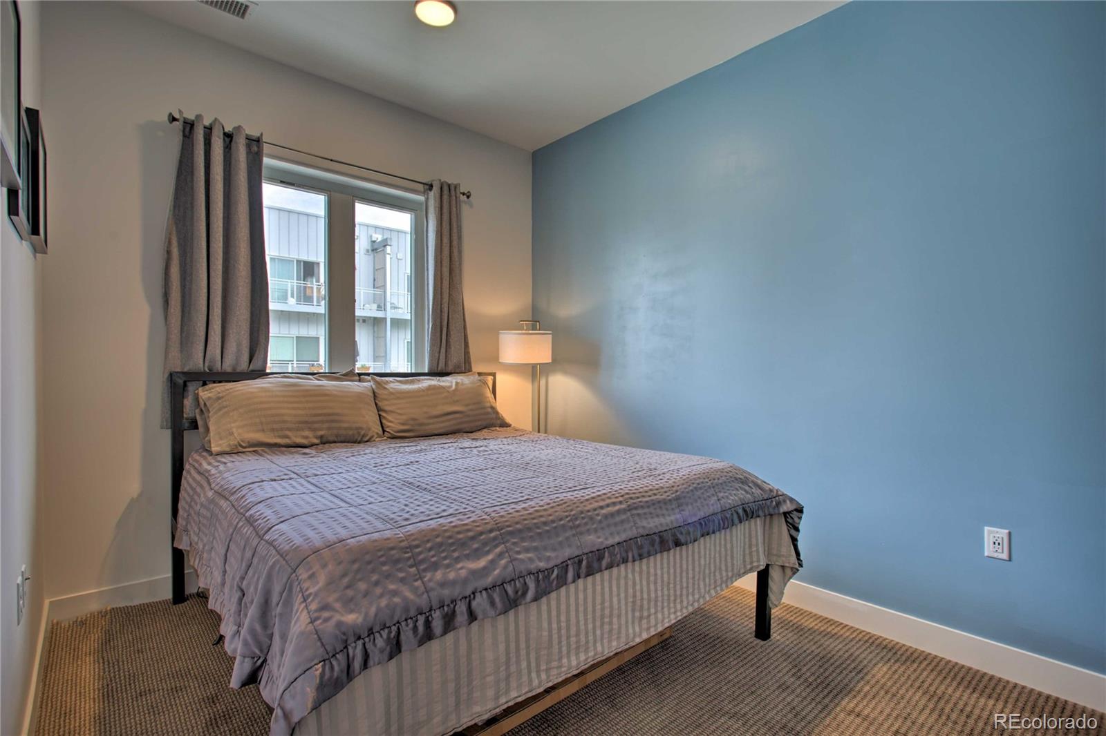 2550 Lawrence Street, Unit RB204 Denver, CO 80205 - Photo 15 of 36 a bedroom with a bed and window