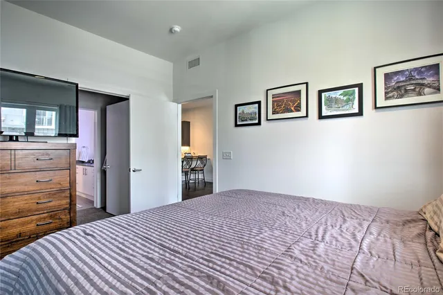 a bedroom with a bed and a dresser