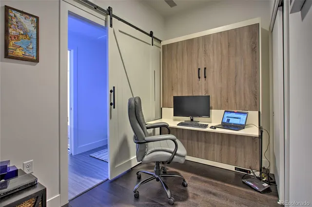 a view of a workspace with furniture and stairs