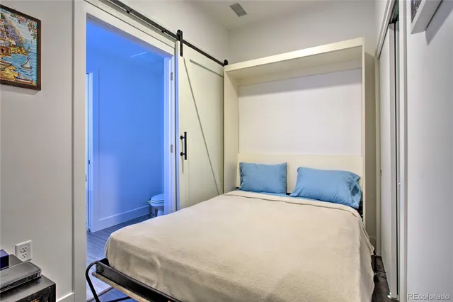 a bedroom with a bed and a table