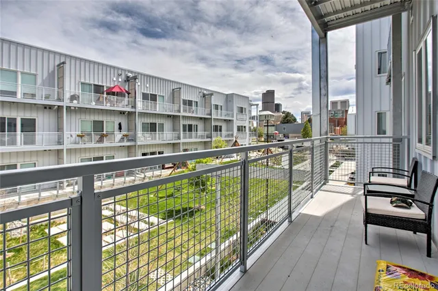 a view of a living room with furniture and a large window