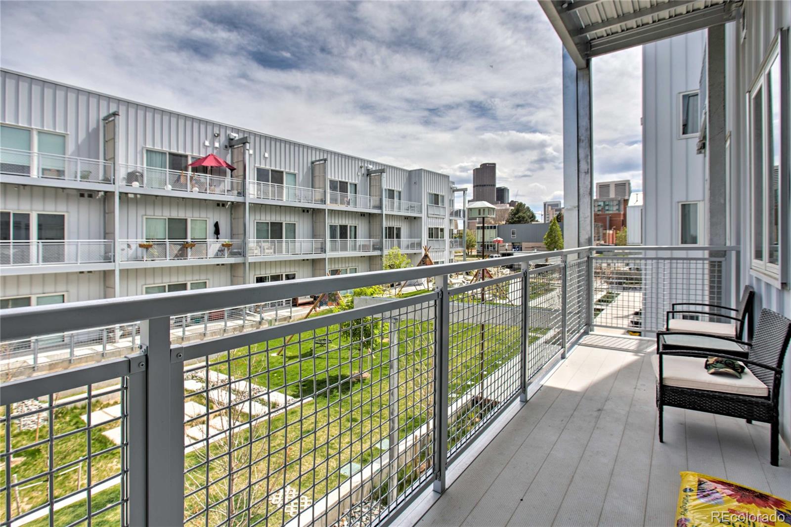 2550 Lawrence Street, Unit RB204 Denver, CO 80205 - Photo 26 of 36 a view of a living room with furniture and a large window