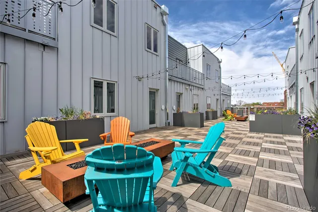 a backyard of a house with barbeque oven table and chairs