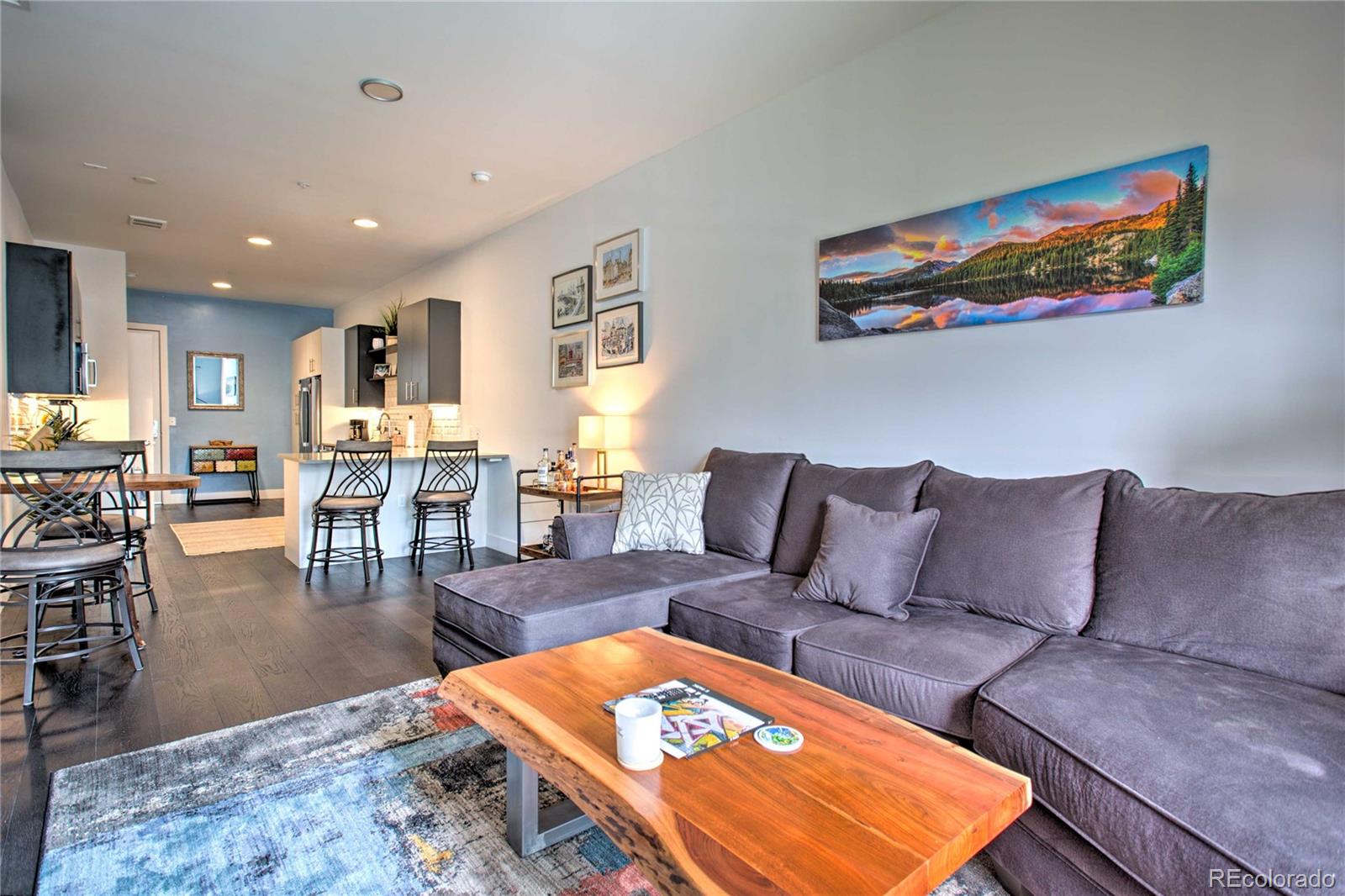 2550 Lawrence Street, Unit RB204 Denver, CO 80205 - Photo 3 of 36 a living room with furniture a rug and a table