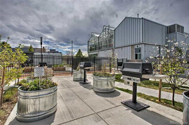a building outdoor space with patio furniture and potted plants