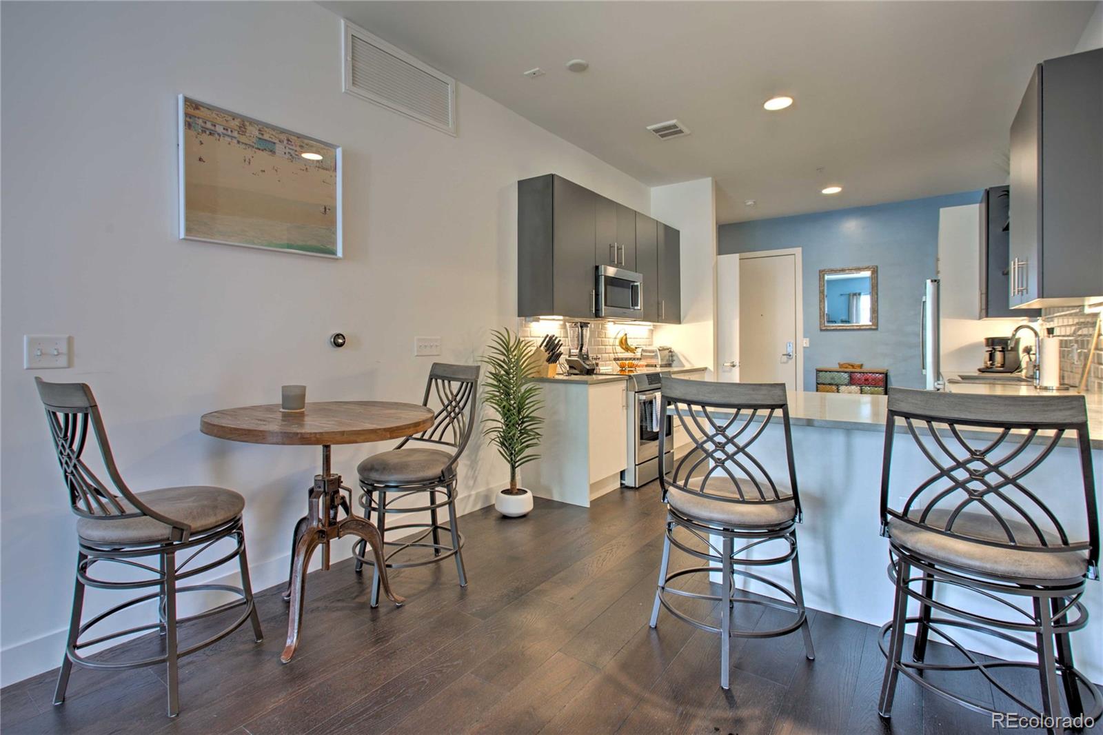 2550 Lawrence Street, Unit RB204 Denver, CO 80205 - Photo 5 of 36 a dining room with furniture and window