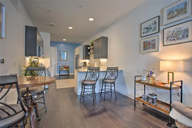 a dining room with furniture and wooden floor