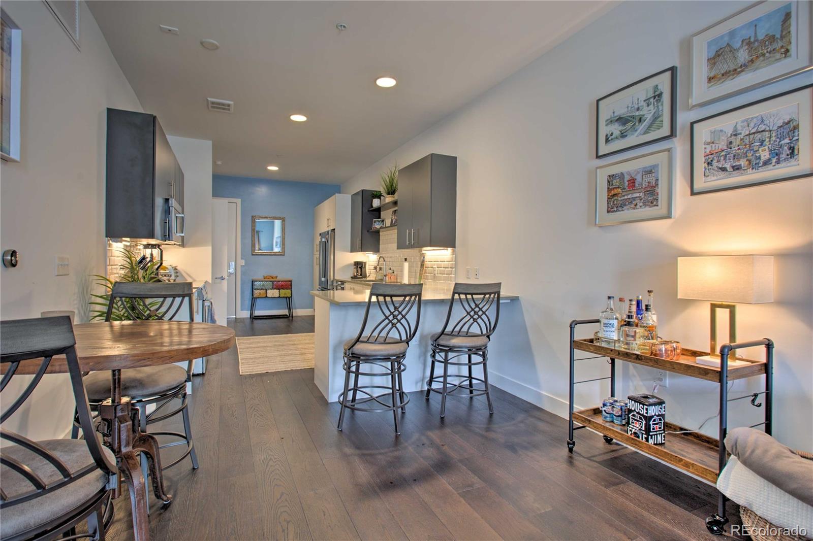 2550 Lawrence Street, Unit RB204 Denver, CO 80205 - Photo 7 of 36 a dining room with furniture and wooden floor
