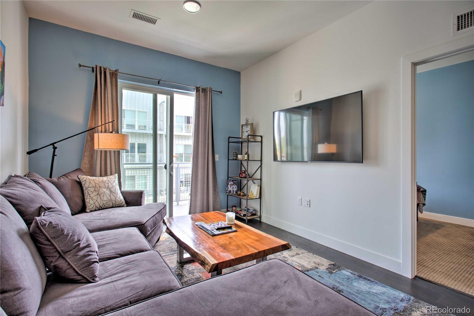 2550 Lawrence Street, Unit RB204 Denver, CO 80205 - Photo 9 of 36 a living room with furniture and a flat screen tv