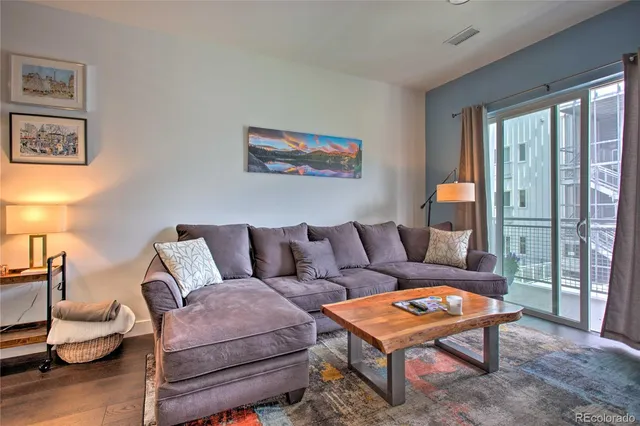 a living room with furniture a lamp and a table