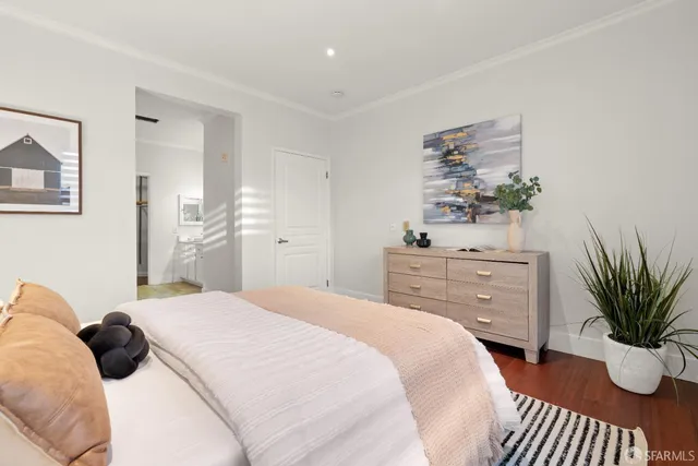 a white toilet sitting next to a white cabinet