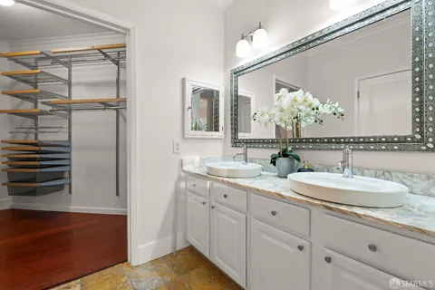 a view of walk in closet with empty racks