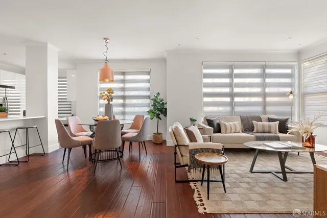 a dining room with furniture a fireplace and wooden floor