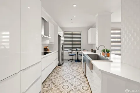 a kitchen that has a sink and a stove in it