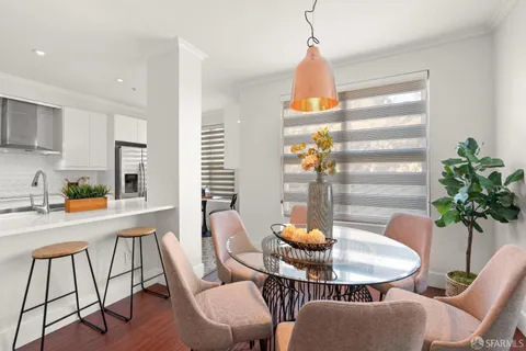 a living room with furniture a fireplace and a large window