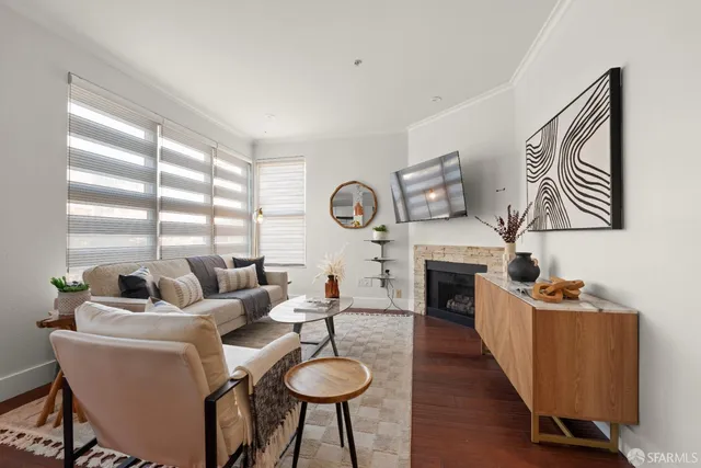 a living room with furniture a fireplace and a flat screen tv