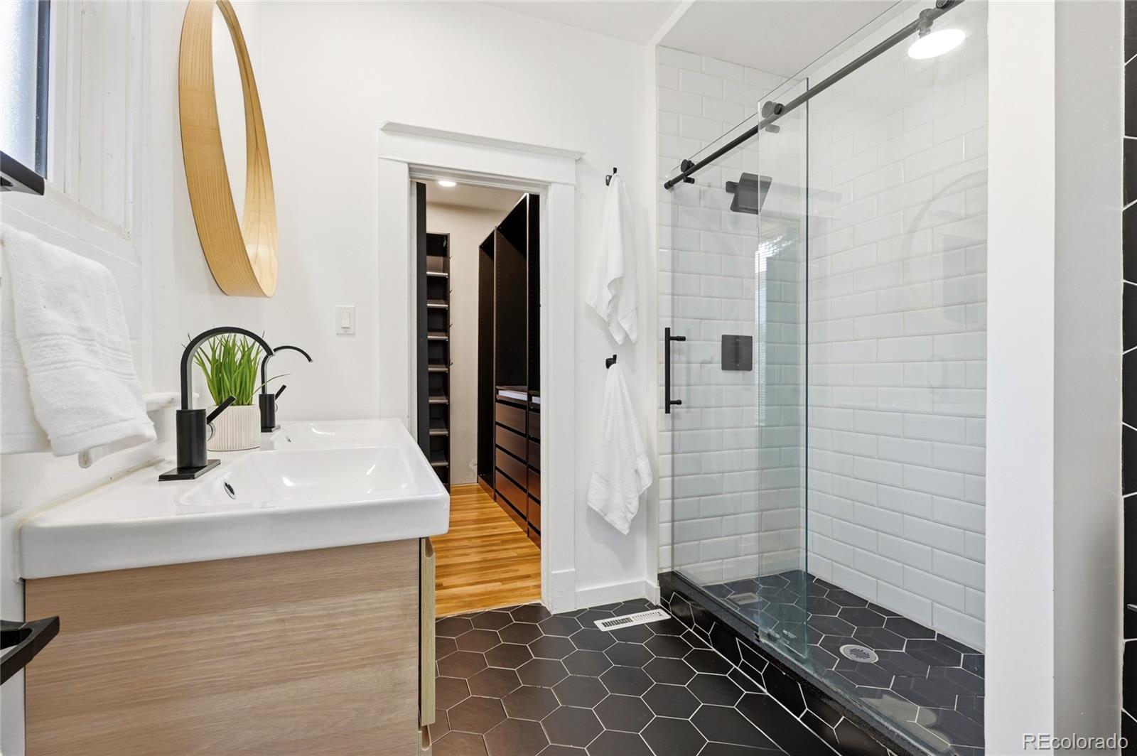4546 Meade Street Denver, CO 80211 - Photo 7 of 35 a bathroom with a sink and a mirror