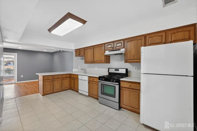 a kitchen with stainless steel appliances a refrigerator sink and stove