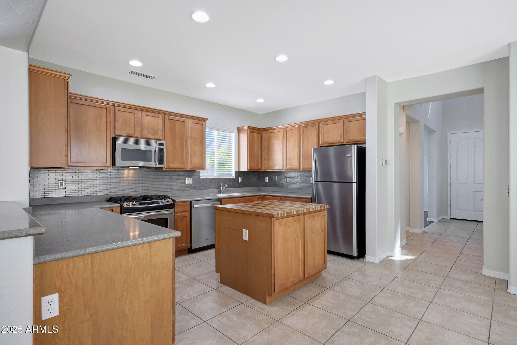 20822 West Ridge Road Buckeye, AZ 85396 - Photo 12 of 46 a kitchen with stainless steel appliances granite countertop a refrigerator stove top oven and sink