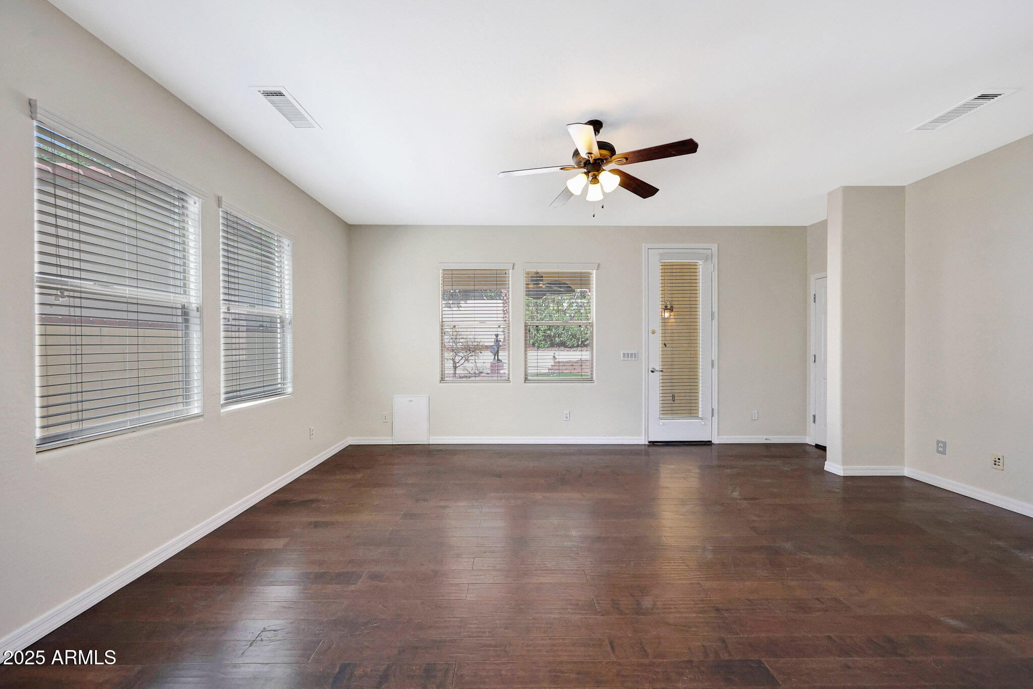 20822 West Ridge Road Buckeye, AZ 85396 - Photo 21 of 46 a view of an empty room with a window and wooden floor