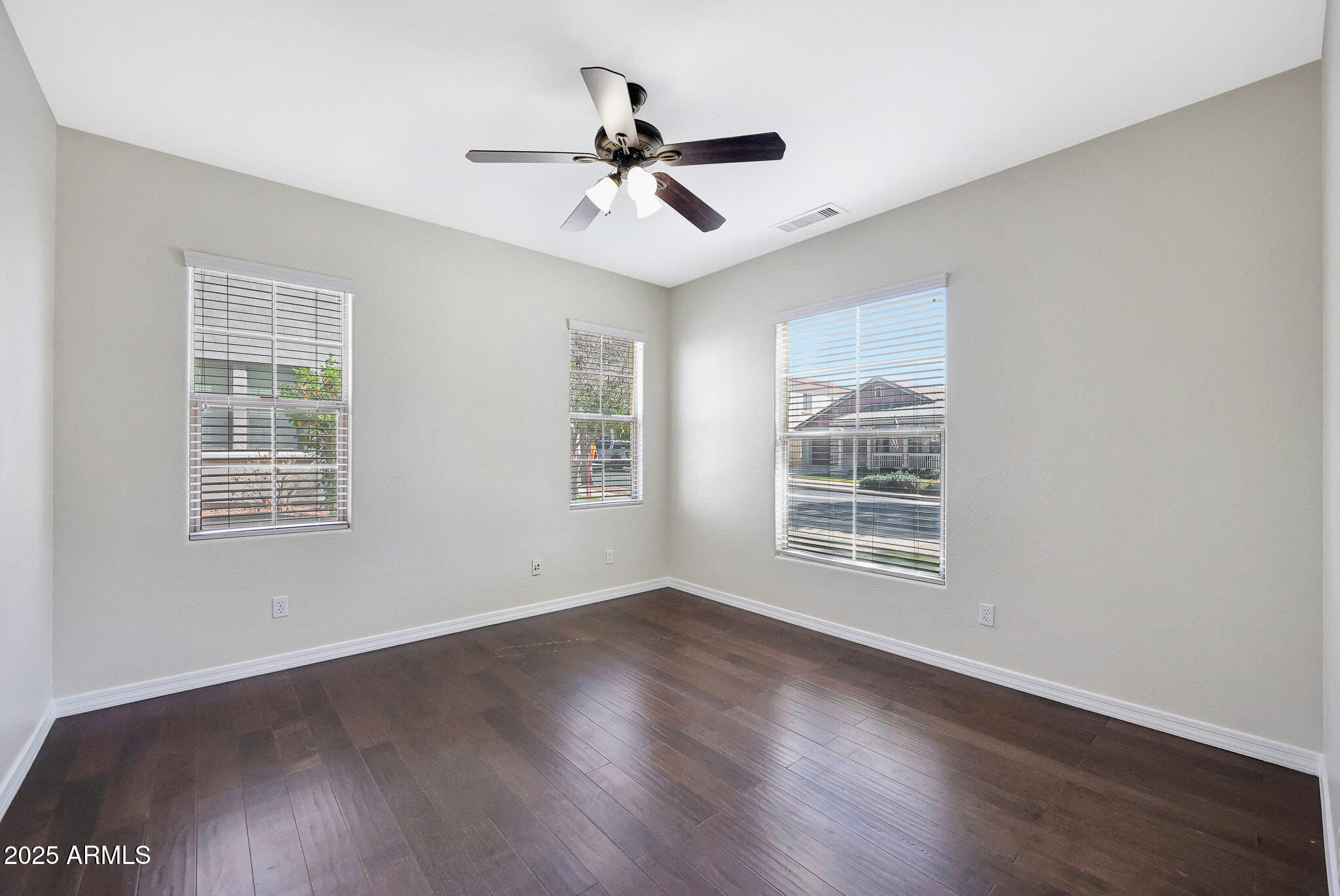 20822 West Ridge Road Buckeye, AZ 85396 - Photo 24 of 46 a view of an empty room with wooden floor and a window