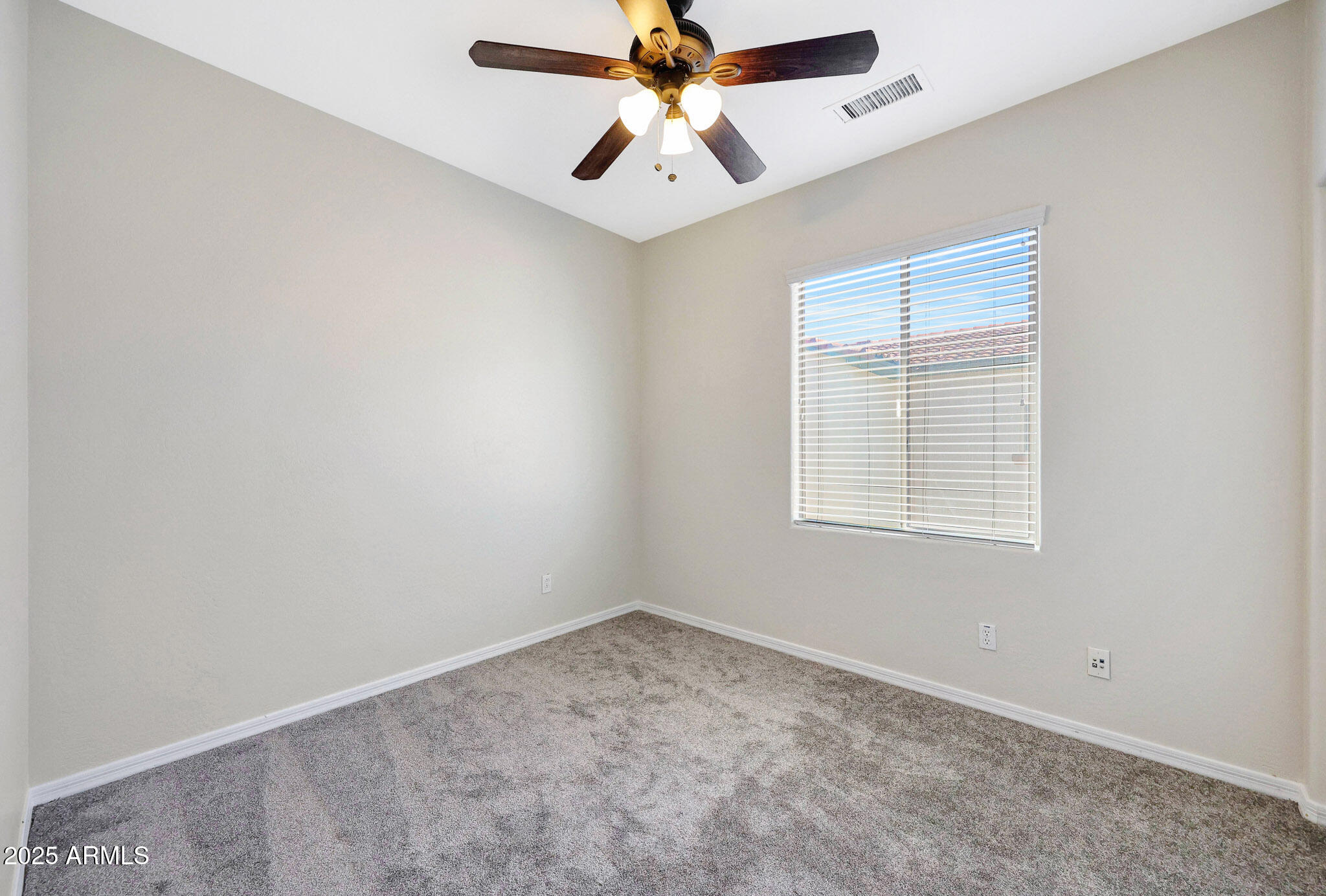 20822 West Ridge Road Buckeye, AZ 85396 - Photo 32 of 46 an empty room with a window and a fan