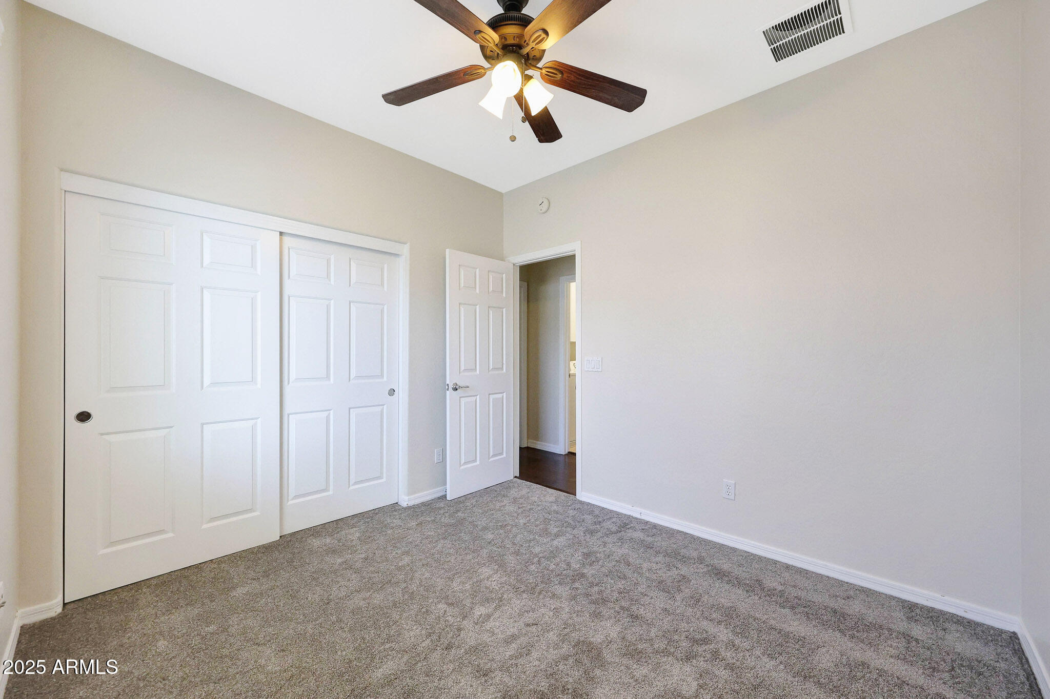 20822 West Ridge Road Buckeye, AZ 85396 - Photo 33 of 46 an empty room with closet and a chandelier fan