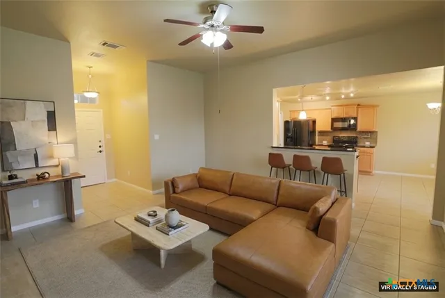 a living room with furniture and a kitchen view