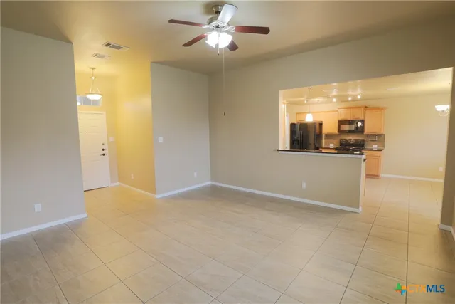 a view of a kitchen with a sink and a chandelier fan