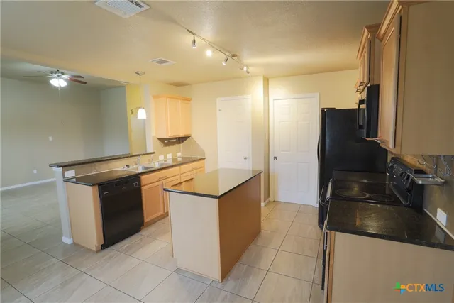 a kitchen with a sink counter top space and appliances