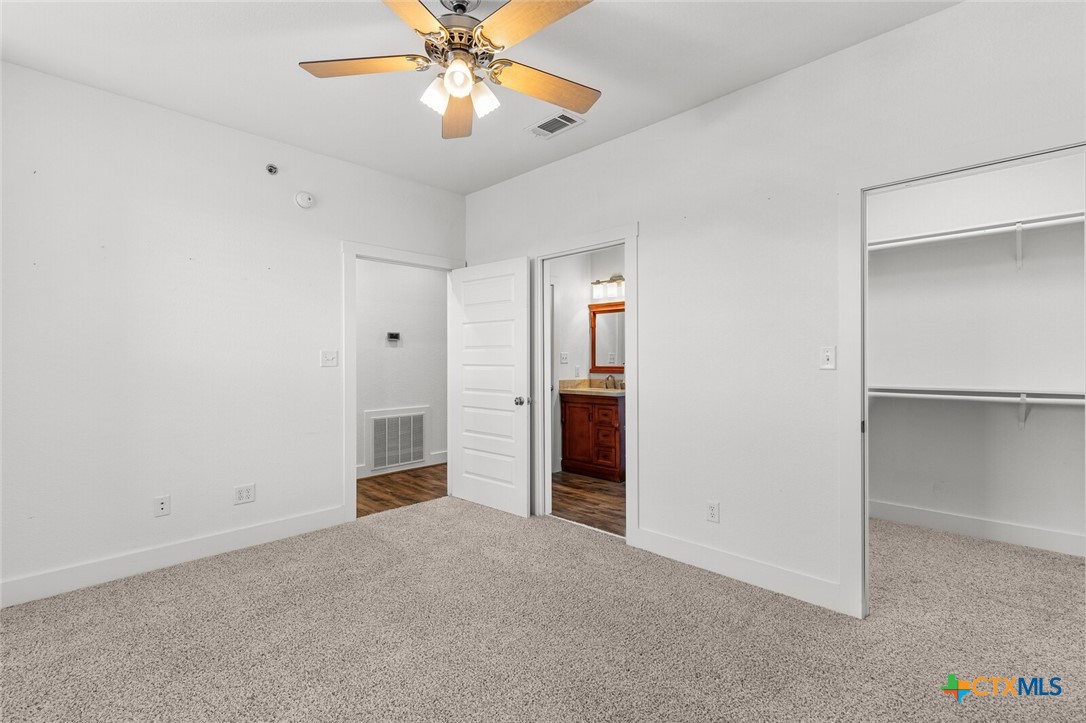 130 Sobrante Road, Unit 112 Belton, TX 76513 - Photo 25 of 48 an empty room with closet and a chandelier fan