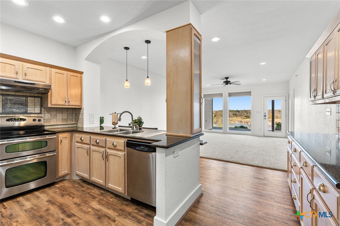 130 Sobrante Road, Unit 112 Belton, TX 76513 - Photo 5 of 48 a large kitchen with stainless steel appliances kitchen island granite countertop a sink and cabinets
