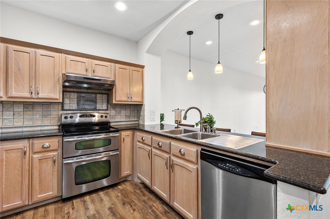 130 Sobrante Road, Unit 112 Belton, TX 76513 - Photo 6 of 48 a kitchen with granite countertop a stove sink and cabinets