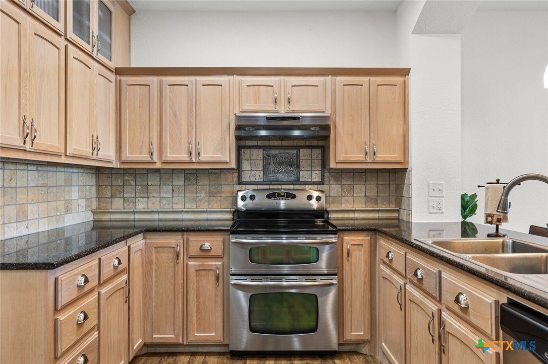 130 Sobrante Road, Unit 112 Belton, TX 76513 - Photo 7 of 48 a kitchen with stainless steel appliances granite countertop a sink a stove and cabinets