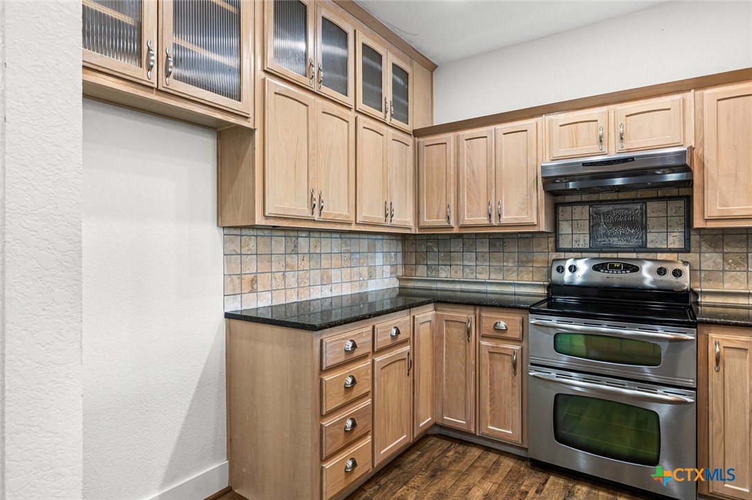 130 Sobrante Road, Unit 112 Belton, TX 76513 - Photo 8 of 48 a kitchen with stainless steel appliances granite countertop a stove and a microwave