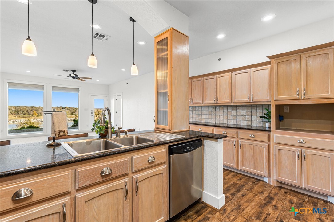 130 Sobrante Road, Unit 112 Belton, TX 76513 - Photo 9 of 48 a kitchen with granite countertop a sink stainless steel appliances and cabinets