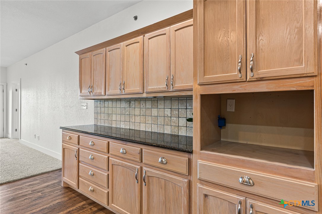 130 Sobrante Road, Unit 112 Belton, TX 76513 - Photo 10 of 48 a kitchen with granite countertop white cabinets and sink