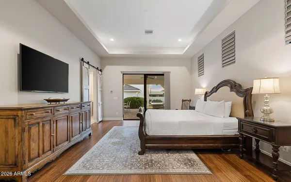 a bedroom with a large bed and a flat screen tv