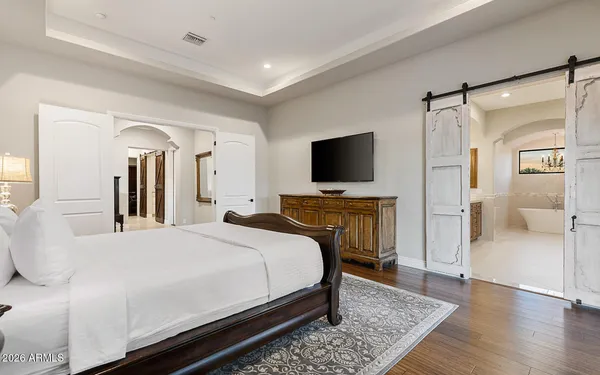a bedroom with a bed and a flat screen television