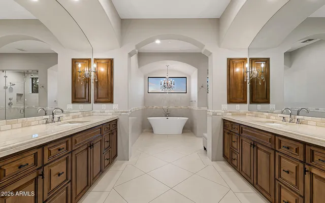 a spacious bathroom with a double vanity sink and a mirror